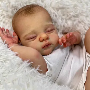 Lifelike 18-inch reborn baby doll in white cotton bodysuit sleeping on plush rug