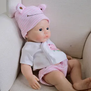 12-inch realistic reborn baby doll in pink frog print outfit on a cozy chair