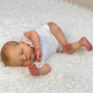 Realistic 18 inch newborn reborn baby doll in white bodysuit sleeping on plush rug