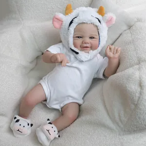 19-inch lifelike reborn baby doll with cow hat and 3D skin texture on plush background