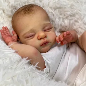 Realistic 18-inch reborn baby doll in white short-sleeved romper on plush rug