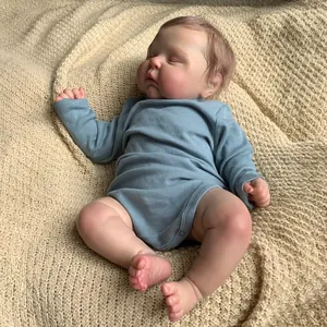 Realistic 19 inch reborn baby doll in blue long sleeve romper on knit blanket