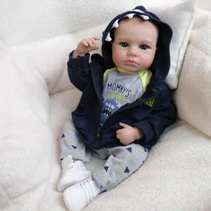 Realistic 19 inch LouLou reborn baby doll wearing a blue shark hoodie and monster outfit