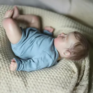 Realistic 19-inch reborn baby doll with 3D skin in blue romper sleeping on beige blanket