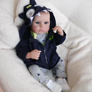 Lifelike 19 inch reborn baby doll LouLou wearing a navy monster hoodie and grey outfit