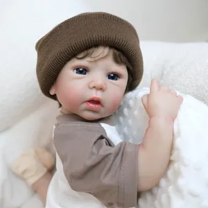 Realistic 19-inch reborn baby doll wearing a brown knit hat and long sleeve tee