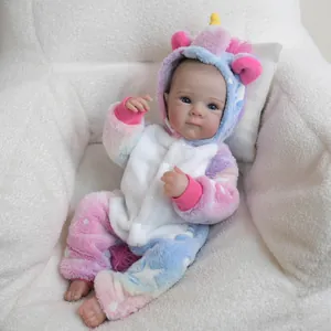 18 inch lifelike reborn baby doll in pink unicorn onesie on white soft wool background
