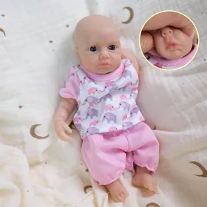 Realistic 8-inch solid silicone baby doll in pink elephant print outfit on soft star fabric