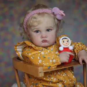 Lifelike 24-inch Reborn baby doll with curly blonde hair in a floral dress and bunny headband