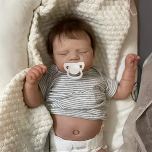 19-inch lifelike reborn baby doll sleeping in striped shirt on white knitted blanket