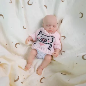 Realistic 8-inch silicone baby doll in pink pig sweater sleeping on moon pattern wrap
