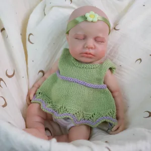 12-inch realistic solid silicone baby doll in green sleeveless knit dress with flower headband