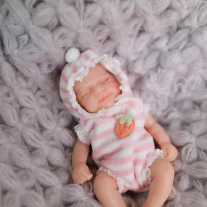 Sleeping 15cm silicone reborn baby doll in pink striped hooded onesie with strawberry motif