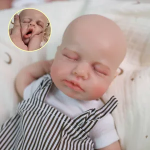 Lifelike 12-inch silicone baby doll in striped overalls with realistic skin texture