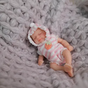 Realistic 15cm mini reborn baby doll in pink striped hoodie on a purple knit blanket