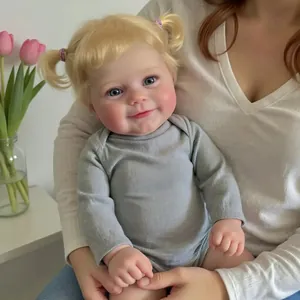 Realistic 20-inch Maddie reborn doll with blonde pigtails in a grey long-sleeve romper