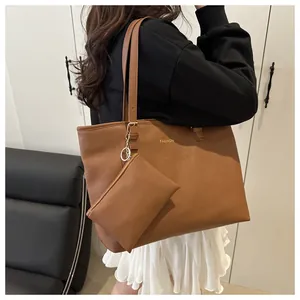 Detail of a brown tote bag with fashion lettering and detachable zip pouch