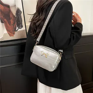Chic silver quilted shoulder bag with gold bow accent and houndstooth strap for women