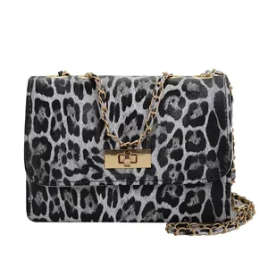 Retro leopard print crossbody bag with gold chain strap and metallic twist lock closure