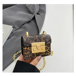 Macro detail of leopard print mini bag with gold chain strap and chunky lock