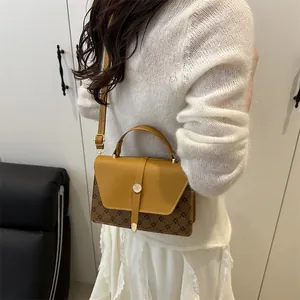 Retro mustard and brown monogram crossbody bag with adjustable strap and top handle