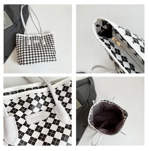 Detail view of checkered tote bag with gold zipper and spacious inner compartment