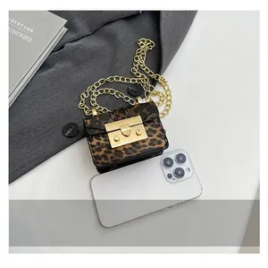 Mini leopard print crossbody bag with gold chain strap shown next to a smartphone