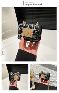 Detailed view of mini leopard print crossbody bag with gold chain strap and square lock