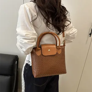 Brown woven texture leather handbag for women featuring a minimalist commute fashion style
