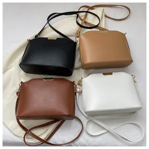 Flat lay of vintage crossbody bucket bags in black, khaki, dark brown and white PU leather