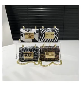 Close-up of animal print mini chain bags with gold hardware in various textures