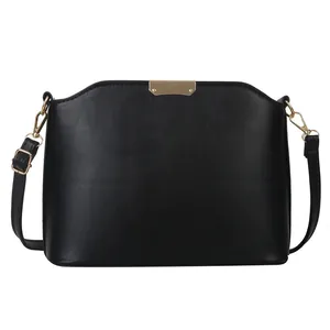 Minimalist black shell bucket bag for women with golden metal hardware and adjustable strap