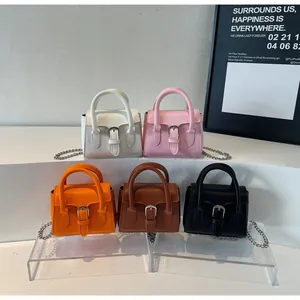Nahaufnahme von Mini-Taschen in fünf Farben mit Retro-Metallschnallen und Kettenriemen