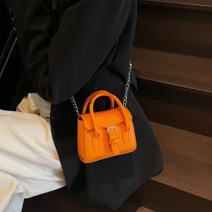 Bright orange mini square leather handbag with silver buckle and metal chain strap