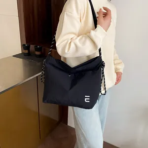 Waterproof black nylon crossbody bag with stylish woven shoulder strap for women