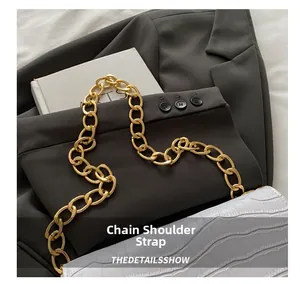 Detail of light purple crocodile embossed shoulder bag with chunky gold chain strap