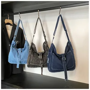 Close-up of casual denim hobo bags showing three vintage colors and metal buckles