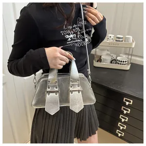 Close-up of shiny silver metallic bag featuring rivet details and wide handles