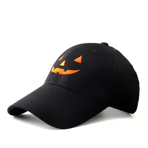 Detailed embroidery of an orange Halloween pumpkin face on a black cotton baseball cap