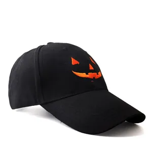Black cotton baseball cap featuring an orange Halloween pumpkin smile embroidery