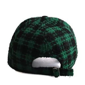 Back view of stylish black and green plaid tweed baseball cap with adjustable buckle
