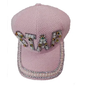 Close-up of pink STAR newsboy cap featuring luxury rhinestones and pearl embellishments