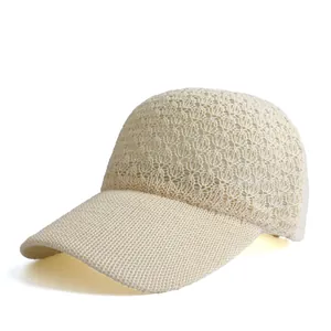 Detailed close-up showing the hollow knit pattern and breathable mesh of the beige baseball cap