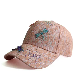 Close-up of lace baseball cap with 3D dragonflies and colorful rhinestones