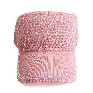 Detail of pink knitted sun visor for women featuring sparkling rhinestones on the brim