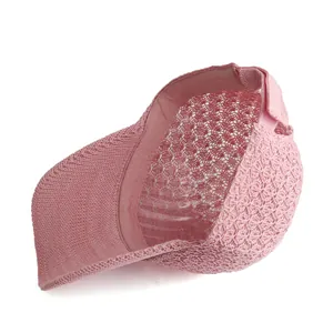 Detail view of pink knit baseball cap featuring breathable mesh and inner lining