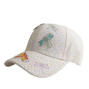 Lace baseball cap with dragonfly embellishments and rhinestones in cream white
