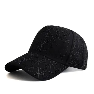 Detailed view of the rhinestone-studded letter M and diamond texture on the black cap