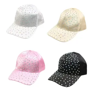 Detail of four rhinestone baseball caps in white, beige, pink and black satin fabric