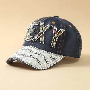 Detail of denim baseball cap featuring colorful SEXY rhinestone embellishments on the front